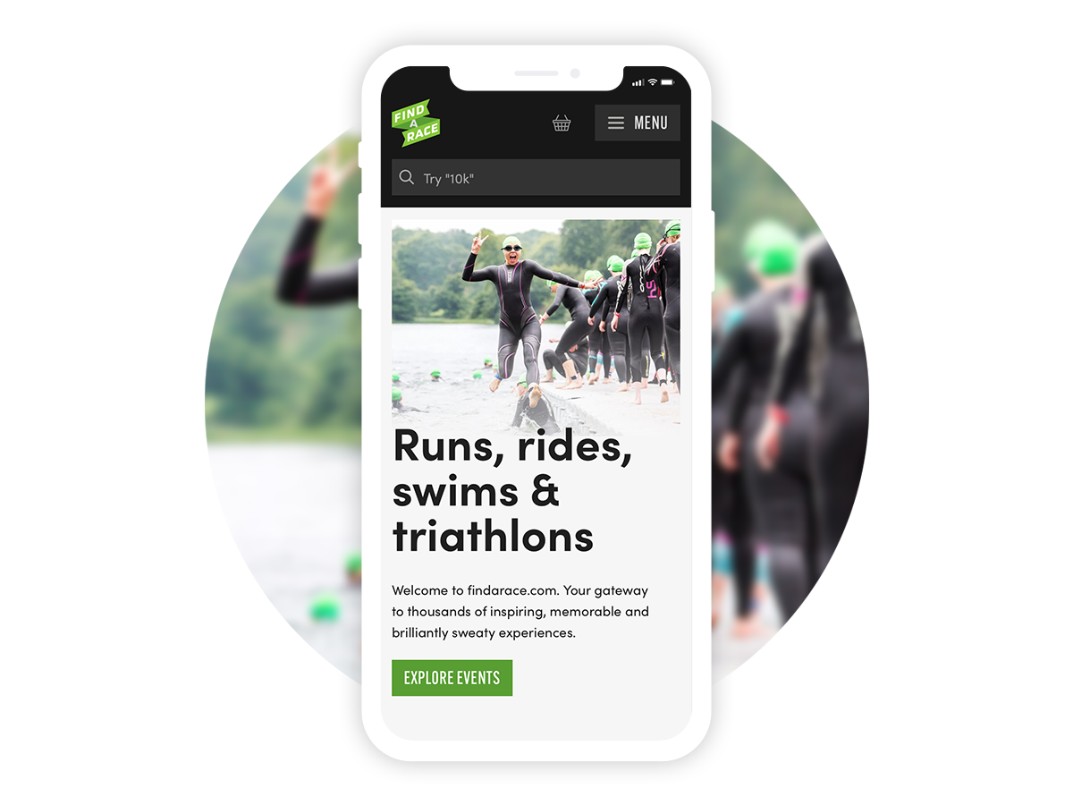 A mobile phone displays the website "findarace" with an image of triathletes in wetsuits and green swim caps standing by a lake. An individual in the foreground waves. The text reads, "Runs, rides, swims & triathlons" and "Explore events" with a "Try 10k?" search bar.
