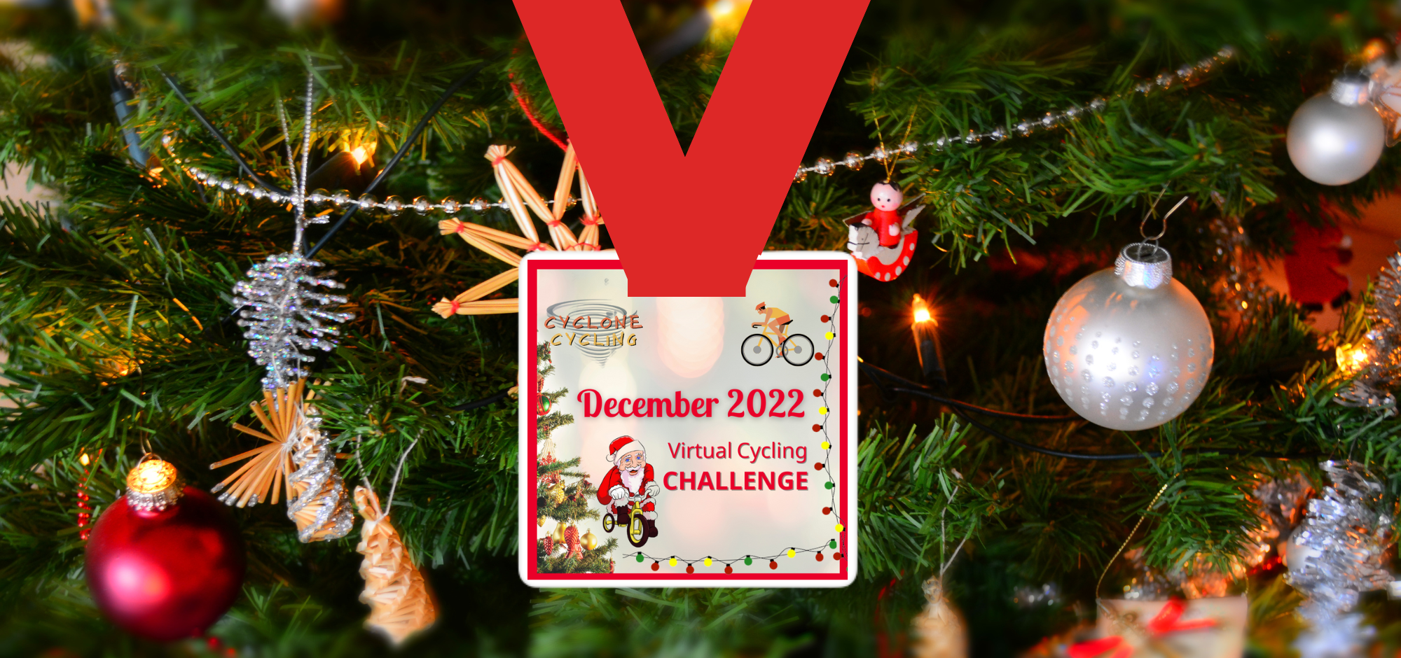 A Christmas tree adorned with various ornaments including stars, baubles, and tinsel. Hanging in the center is a virtual cycling challenge medal for December 2022, featuring festive graphics such as Santa Claus on a bike, a reindeer, and colorful lights.