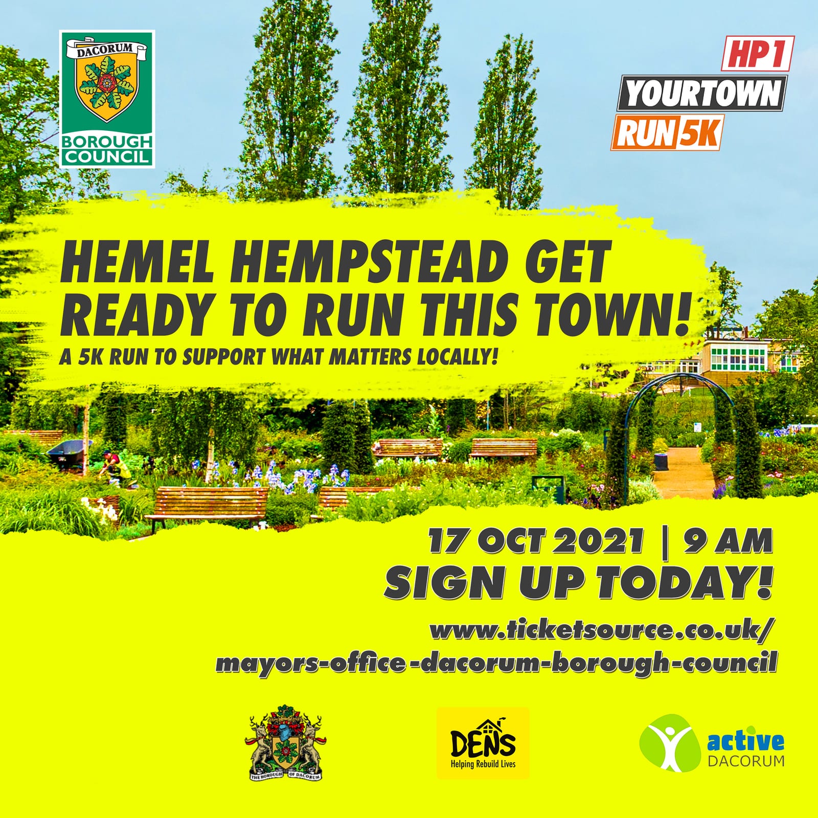 A promotional poster for a 5K run in Hemel Hempstead on October 17, 2021, at 9 AM. The text encourages signing up at ticketsource.co.uk, with logos of supporting organizations like Dacorum Borough Council, DENS, and Active Dacorum. The background features a park.