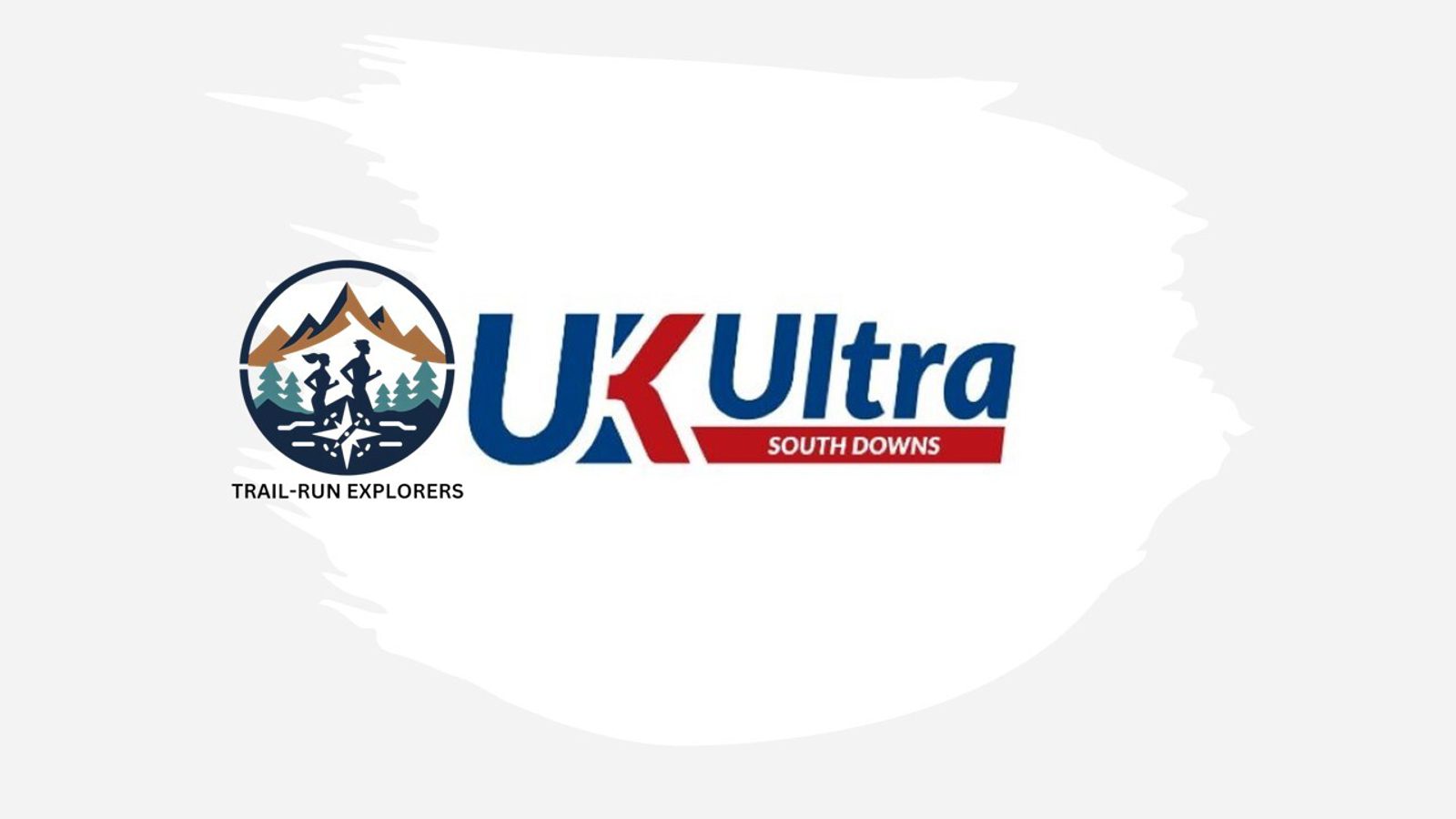 Logo for UK Ultra South Downs, featuring the text "UK Ultra SOUTH DOWNS" in blue and red on a white background. To the left, there is an emblem of mountains with a runner and the words "TRAIL-RUN EXPLORERS" beneath it.