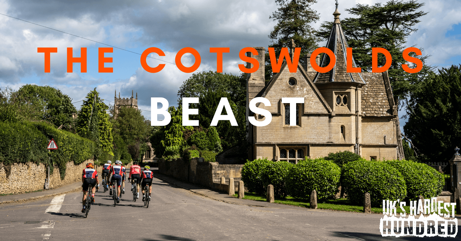 Cyclists ride along a picturesque road with lush greenery and an old stone building with pointed roofs in the background. The text "The Cotswolds Beast" is prominently displayed. Additional text "UK's Hardest Hundred" is visible in the bottom right corner.