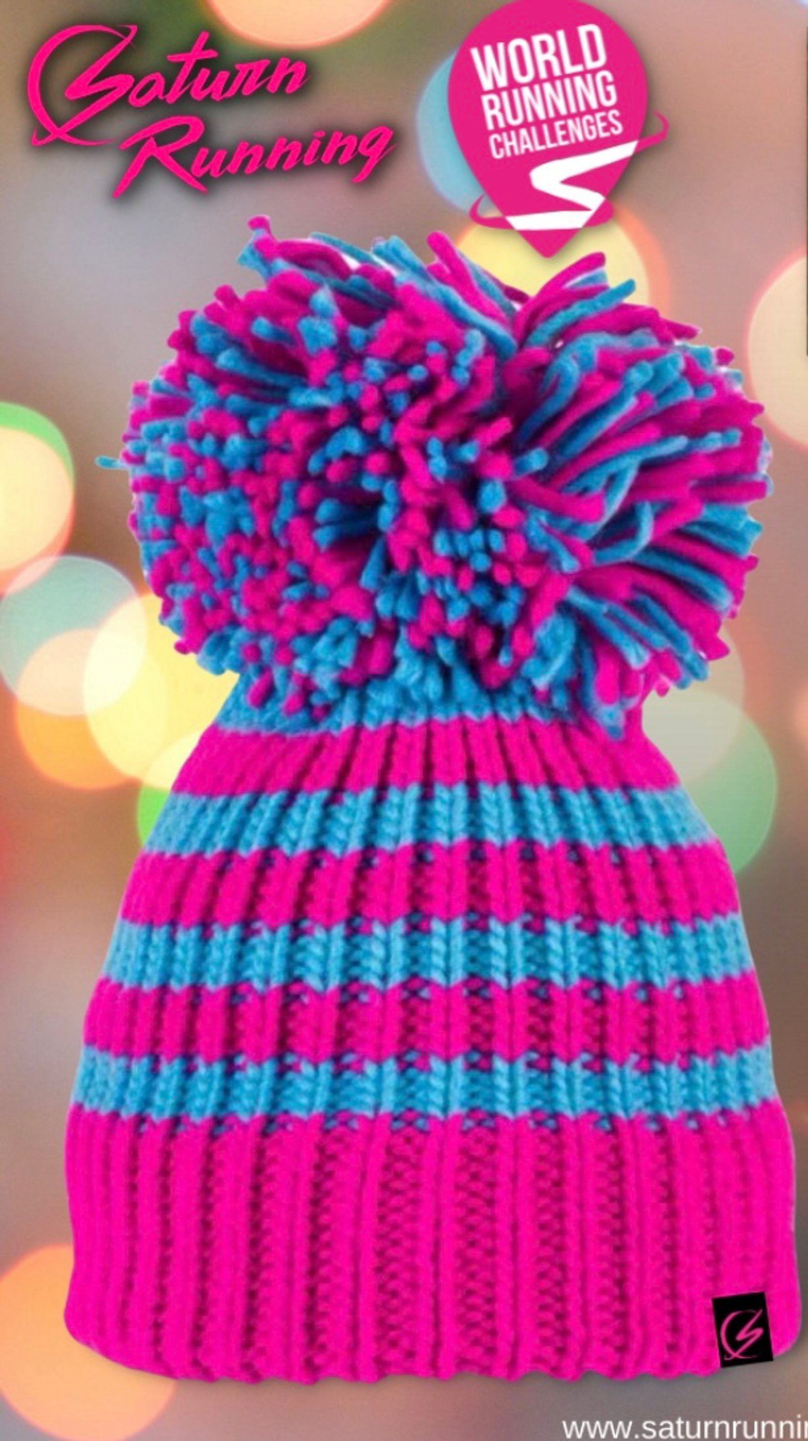 A brightly colored knit hat with pink and turquoise stripes, featuring a large pom-pom made of pink and turquoise yarn at the top. The background is blurred with colorful lights. Text on the image reads "Saturn Running" and "World Running Challenges.