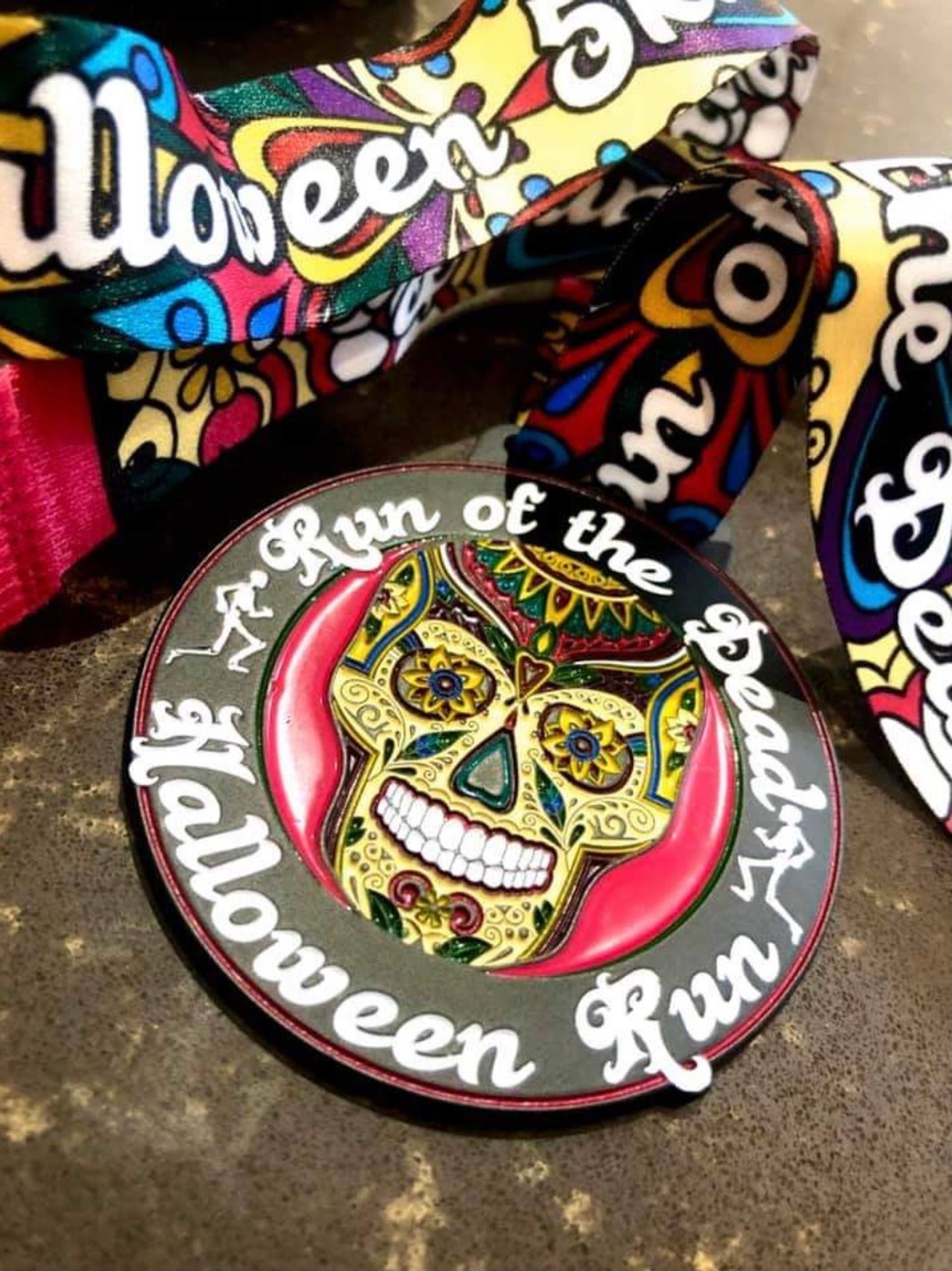 A colorful medal for a "Run of the Dead" Halloween run event featuring a vibrant, intricate sugar skull with floral designs. The medal is attached to a festive, patterned ribbon with "Halloween Run" and "Run of the Dead" text.