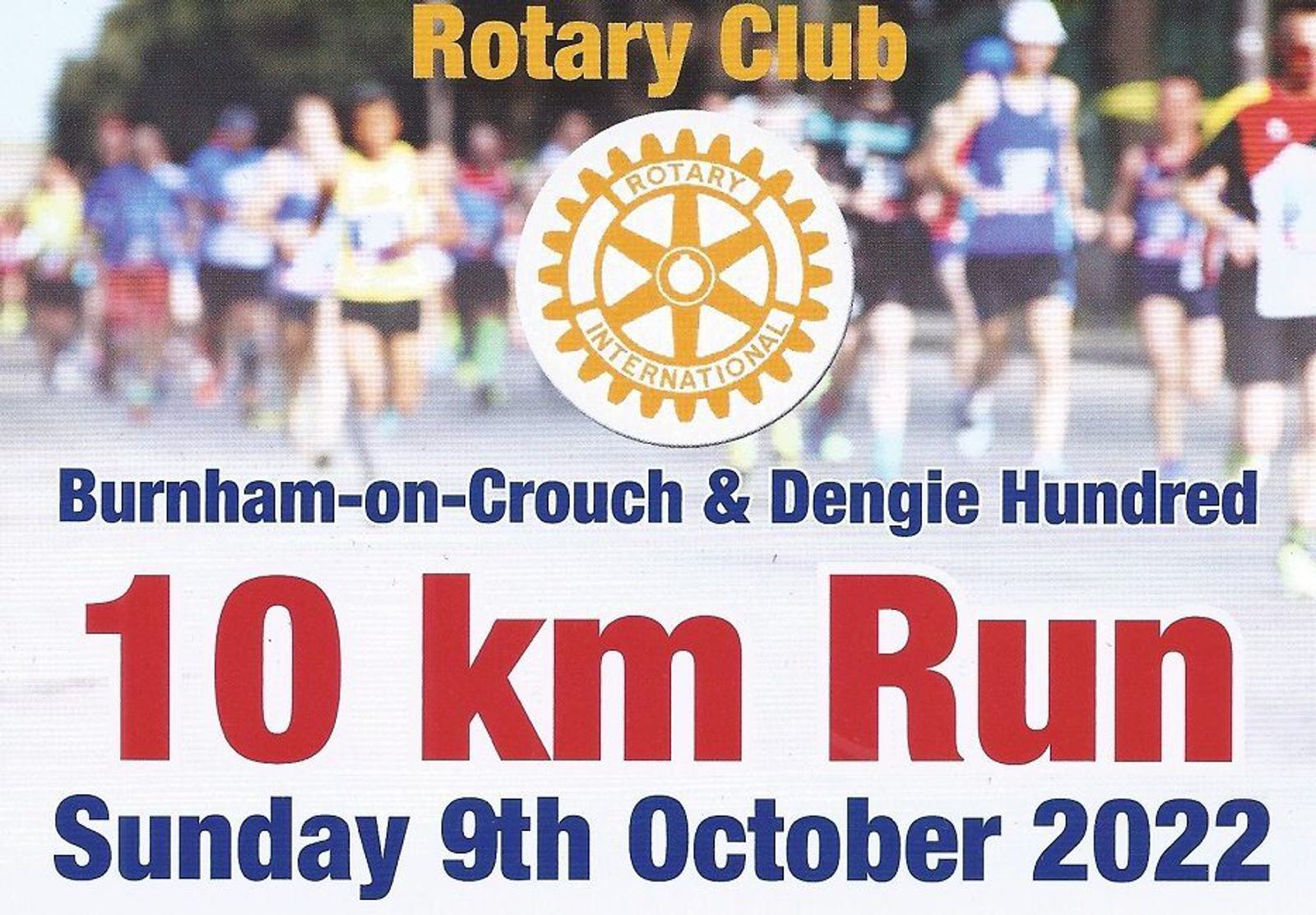 A colorful promotional poster for a Rotary Club event. The text reads, "Burnham-on-Crouch & Dengie Hundred 10 km Run, Sunday 9th October 2022." The background shows blurred runners. The Rotary International logo is prominently displayed at the top.