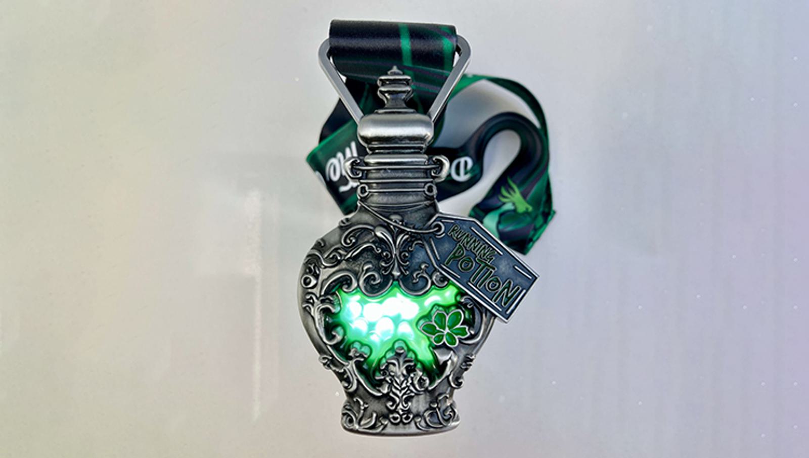 An intricately designed perfume bottle with a glowing green interior, featuring ornate metalwork and a label that reads "Liquid Luck Potion." The bottle is attached to a green and black ribbon.