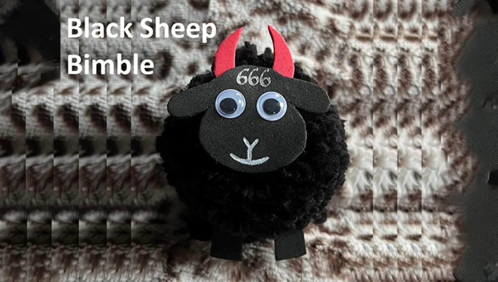 A fluffy black sheep figure with red horns, googly eyes, and the number 666 on its forehead stands on a textured brown and white surface. Text in the top left reads "Black Sheep Bimble.