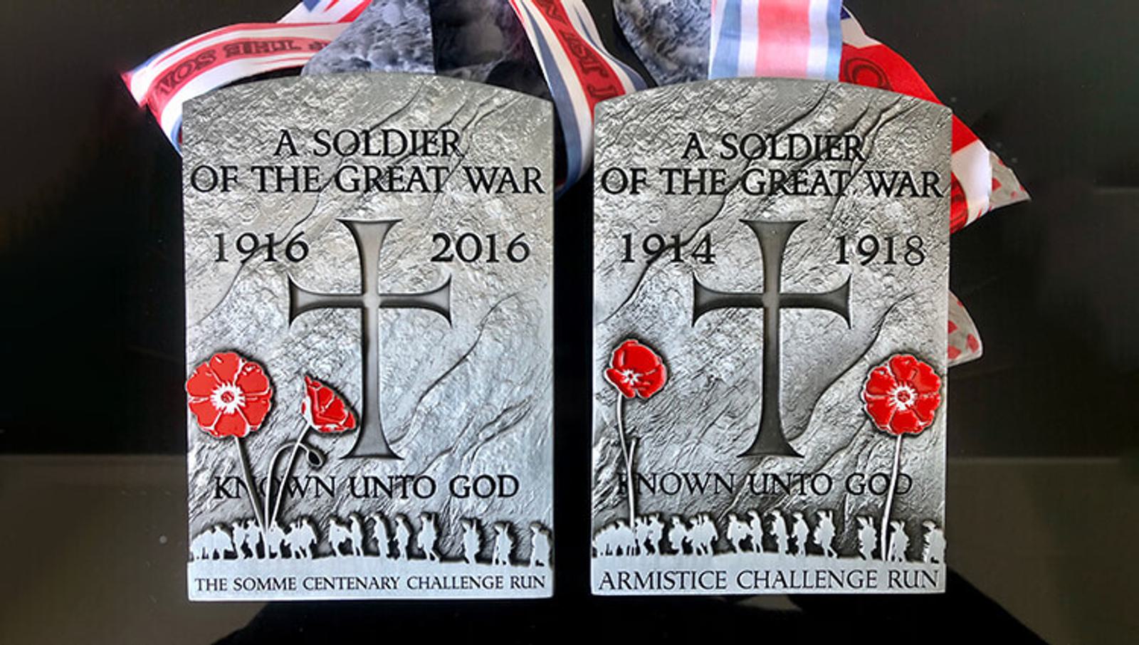 Two memorial plaques commemorating soldiers of the Great War. The left plaque is inscribed with "A SOLDIER OF THE GREAT WAR 1916 - 2016 KNOWN UNTO GOD THE SOMME CENTENARY CHALLENGE RUN," and the right with "1914 - 1918 NOW UNTO GOD ARMISTICE CHALLENGE RUN.