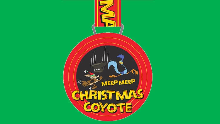 A race medal featuring Wile E. Coyote and the Road Runner from Looney Tunes. The characters are depicted in a chase scene with “Meep Meep” text and falling anvils. The words "Christmas Coyote" are written at the bottom. The background is green.