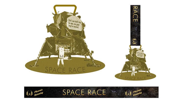 Gold-toned model of a lunar module with "Space Race" text. Includes a rectangular base and a vertical medal ribbon. The module has a speech bubble saying, "It's one small leap for man, one giant step on burnout.