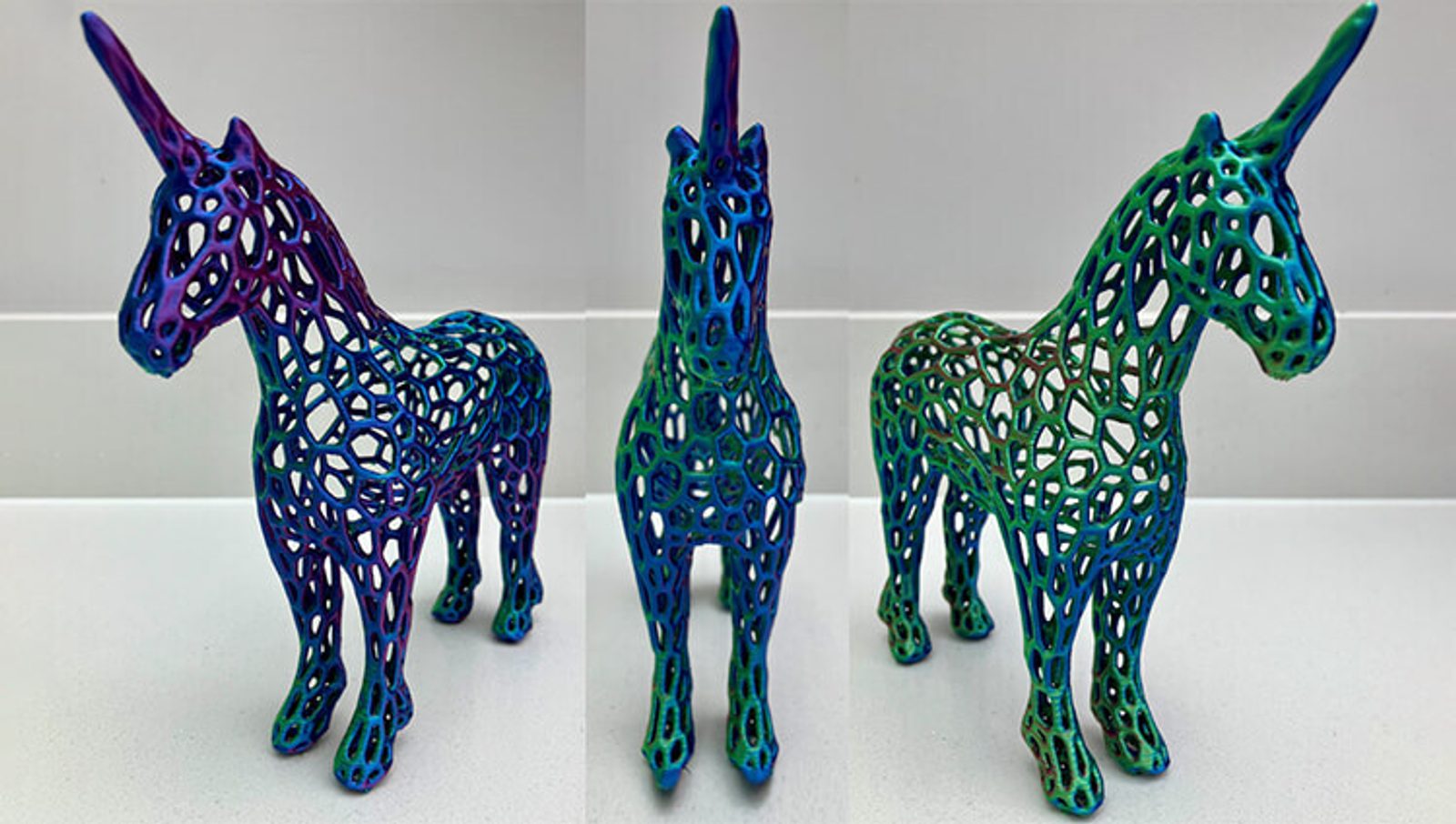 A 3D-printed unicorn figurine with a colorful, gradient pattern of purples, blues, and greens, featuring a lattice-like, open framework design shown from three angles.