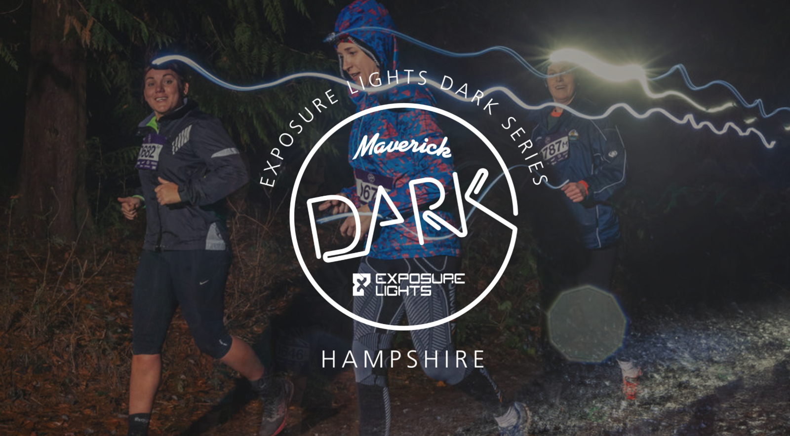Three runners jog through a dark, wooded path with headlamps illuminating their way. The image is overlaid with the logo and text: "Exposure Lights Dark Series. Maverick DARK. Exposure Lights. Hampshire." There is a light trail effect in the background.