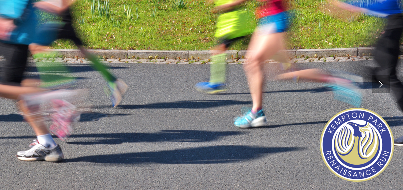 Blurry image of runners in motion on a paved path, with a grassy area in the background. The runners' outfits are colorful and varied. In the bottom right corner is a logo reading "KEMPTON PARK RENAISSANCE RUN" featuring a stylized shoe and laurel wreath.