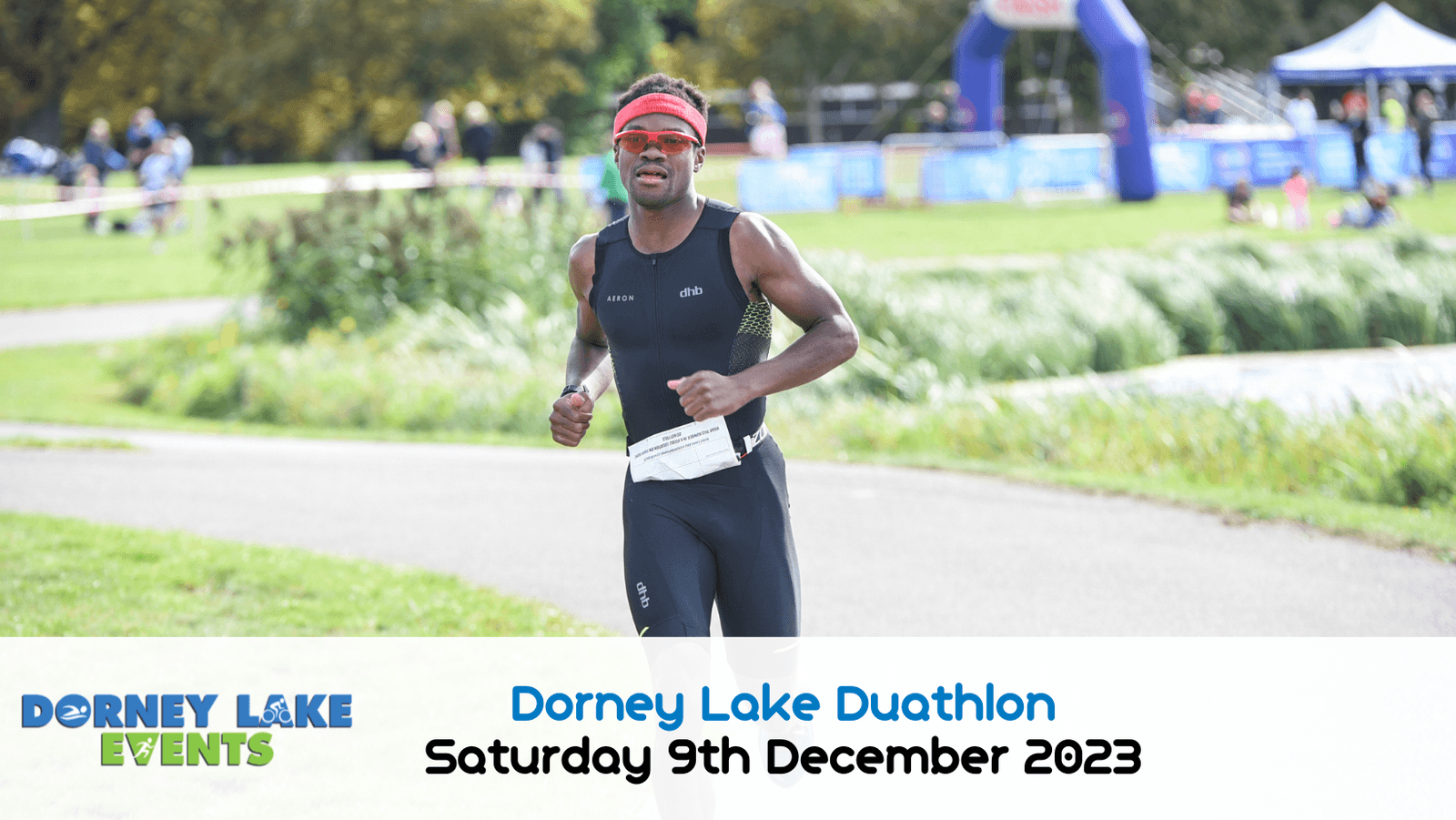 A man in athletic gear and a red headband is running outdoors on a paved path surrounded by greenery. The event banner at the bottom reads "Dorney Lake Duathlon Saturday 9th December 2023" alongside the Dorney Lake Events logo.