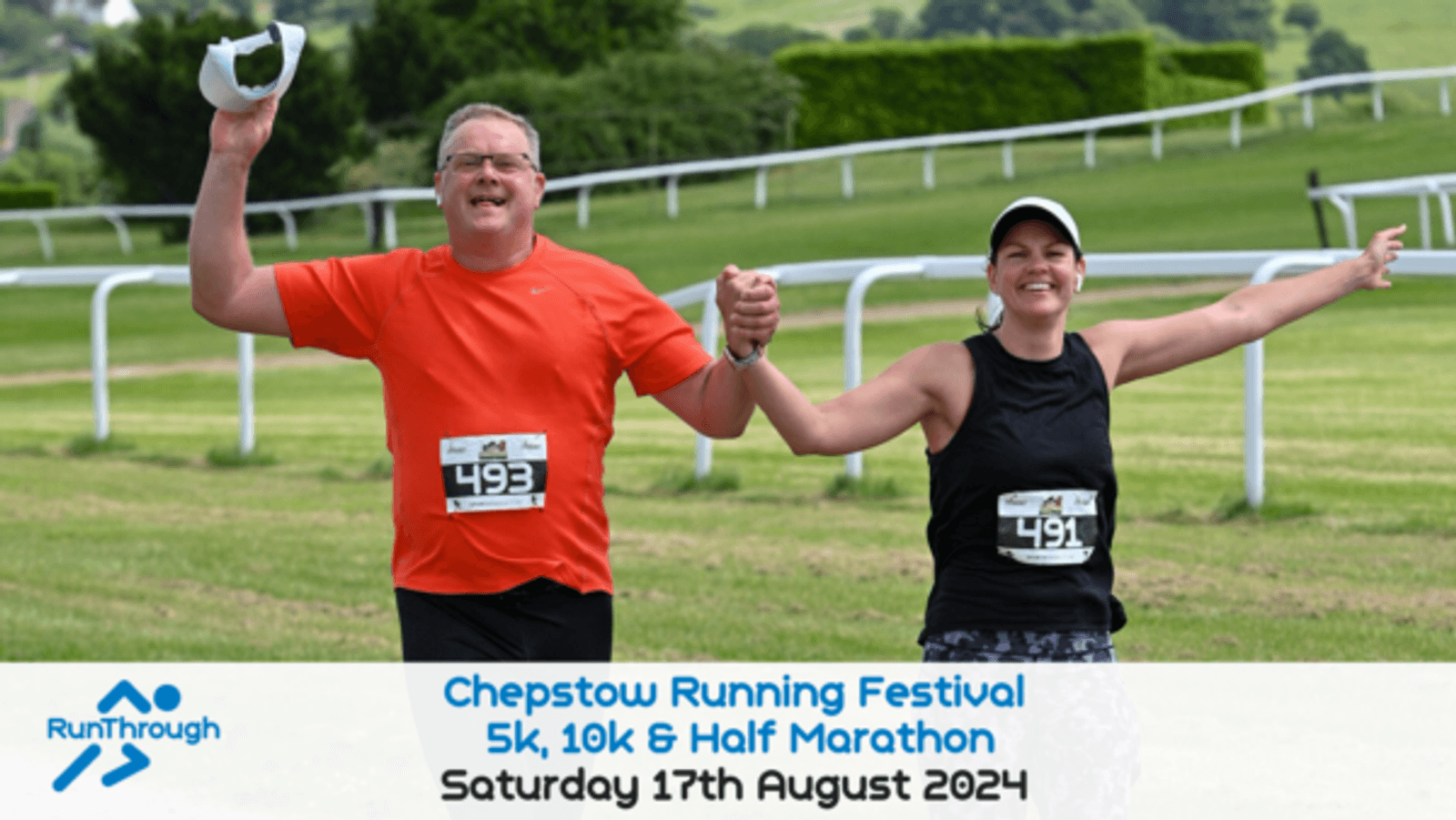 Two smiling runners, wearing race bibs 493 and 491, hold hands and raise their arms in celebration as they cross a grassy finish line. The background displays a racecourse barrier and green hills. Text on the image reads "Chepstow Running Festival 5k, 10k & Half Marathon, Saturday 17th August 2024".