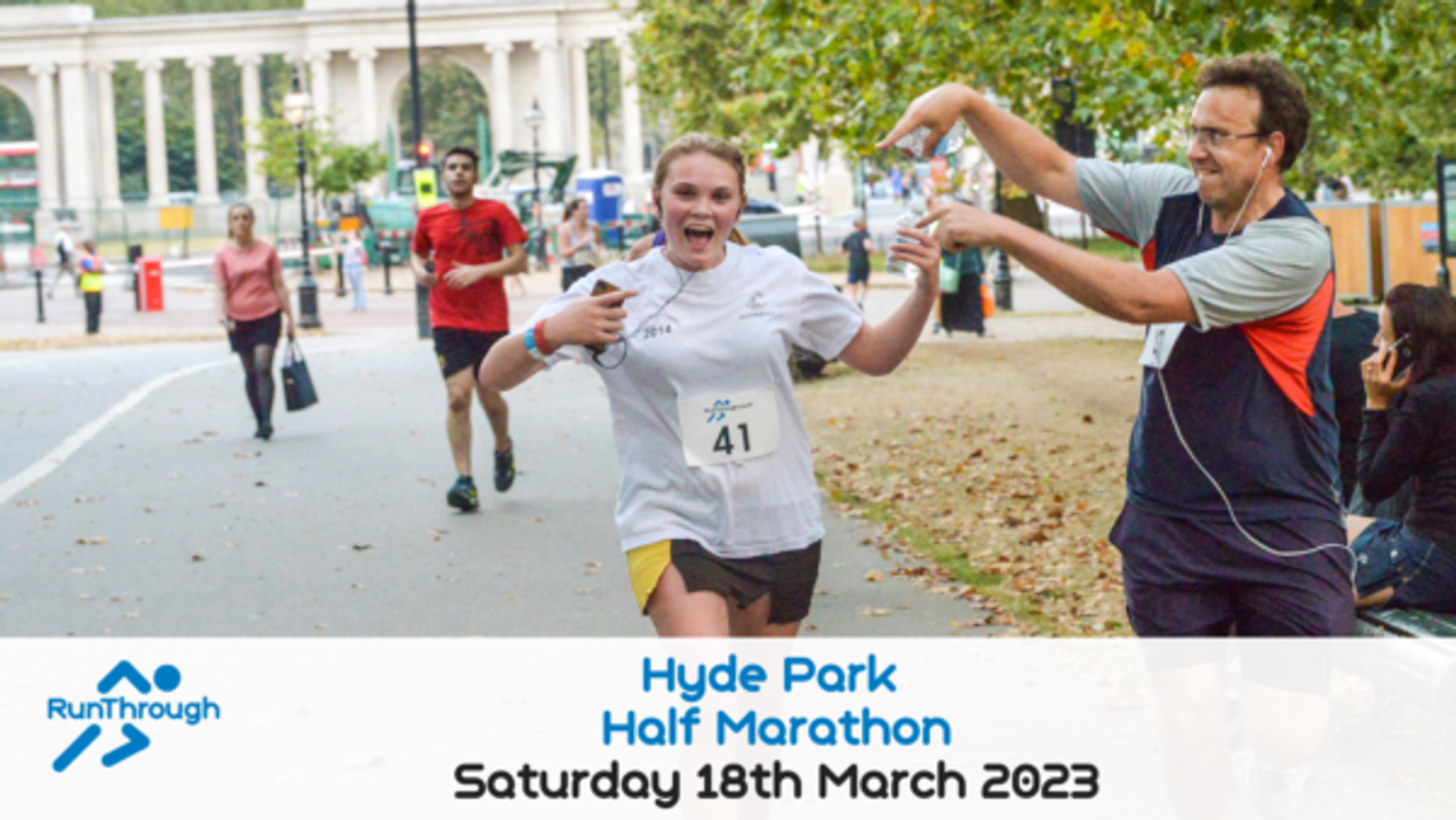 A smiling runner wearing a white shirt with the number 41 is crossing the finish line while a man wearing a blue shirt claps enthusiastically beside them. The event details are "Hyde Park Half Marathon, Saturday 18th March 2023" with the RunThrough logo on the bottom left.