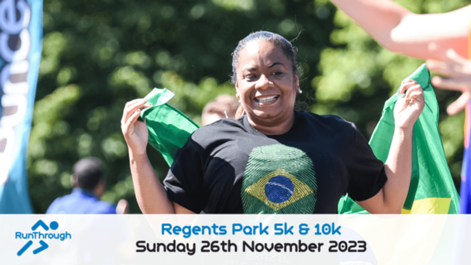 A woman is smiling and holding a Brazilian flag behind her back while running, wearing a t-shirt with a Brazilian flag design. The banner at the bottom displays "Regents Park 5k & 10k" and "Sunday 26th November 2023" with the RunThrough logo on the left.