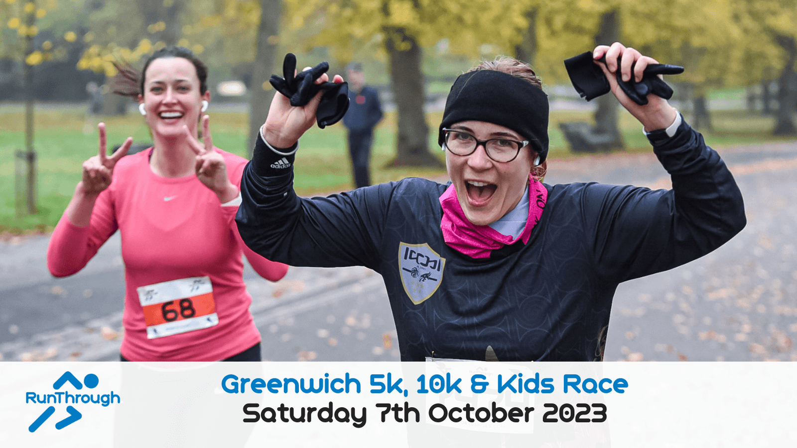 Two participants smile as they run in a park during a race event. The runner in front wears a dark shirt and winter gear, holding up her arms in celebration. The runner behind, wearing a pink shirt, is making a peace sign. Event details at the bottom read "Greenwich 5k, 10k & Kids Race, Saturday 7th October 2023.