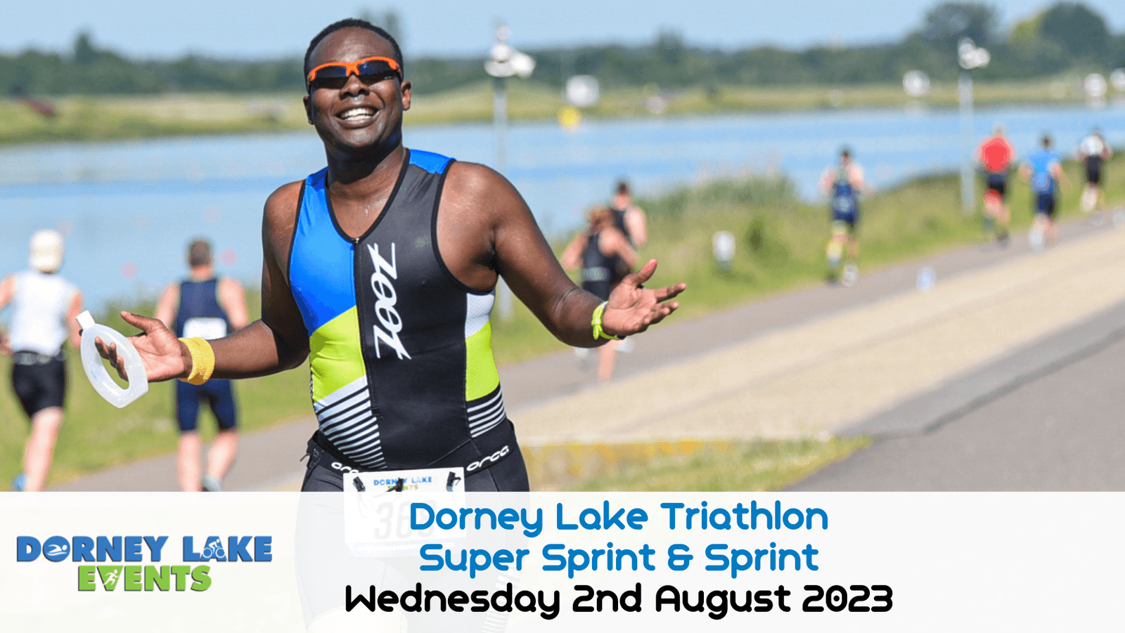 A triathlete smiles while running during the Dorney Lake Triathlon. Other participants are visible in the background near the lake. The event details "Dorney Lake Triathlon Super Sprint & Sprint Wednesday 2nd August 2023" are overlayed on the image at the bottom.
