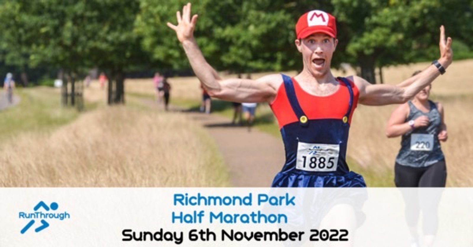 A runner dressed in a Mario-inspired costume enthusiastically raises his arms in excitement while running a race in a park. Other participants are visible in the background. Text at the bottom reads "Richmond Park Half Marathon, Sunday 6th November 2022.
