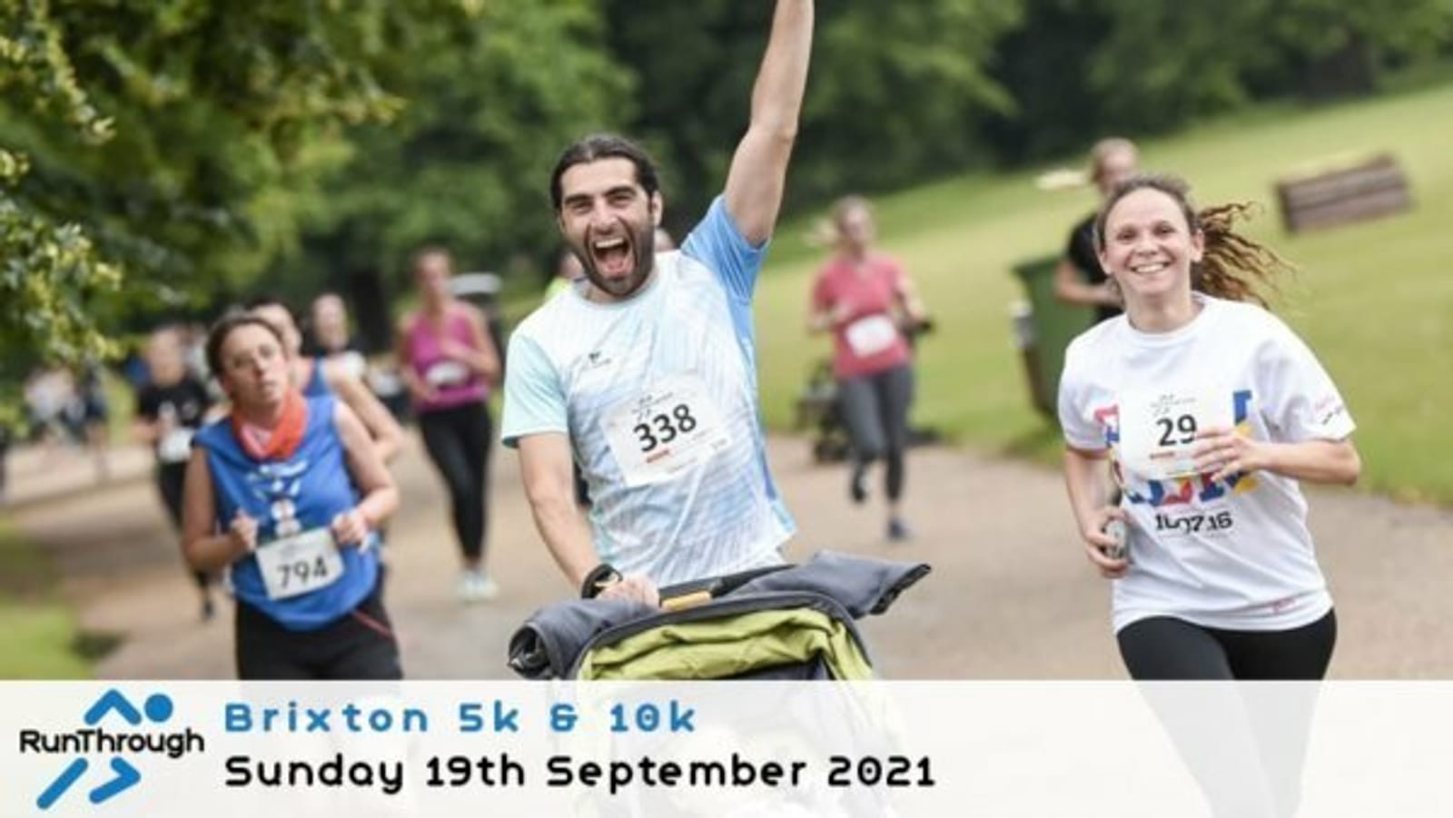 Runners participating in an outdoor Brixton 5k and 10k event. A man in a blue shirt pushes a stroller, raising his arm in excitement, while a smiling woman runs beside him. Other participants are visible in the background. A banner shows the event details.