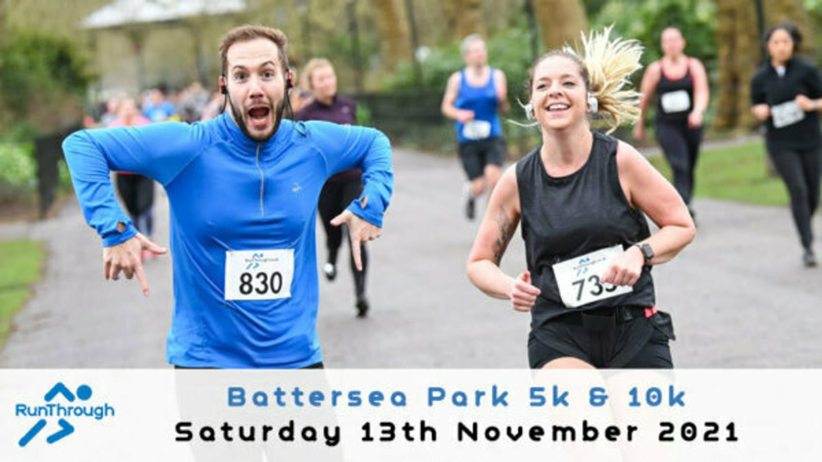 Two people are running in a park, wearing race bibs numbered 830 and 735. They appear to be during a fun run event. The man wears a bright blue shirt, making a playful pose, while the woman smiles. Text reads "Battersea Park 5k & 10k, Saturday 13th November 2021.