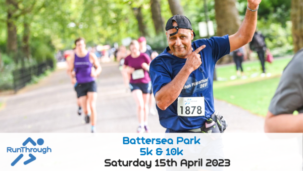 A man wearing a blue shirt, black cap, and race number "1878" smiles and gives a thumbs-up while running on a tree-lined path in Battersea Park. Other runners can be seen in the background. Text on the image reads, "RunThrough Battersea Park 5k & 10k, Saturday 15th April 2023.