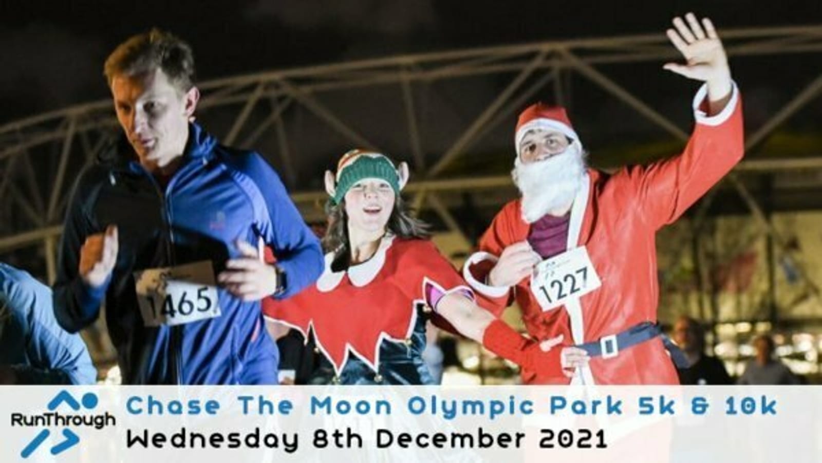 Three runners in festive costumes participating in the Chase The Moon Olympic Park 5k & 10k event. The runner on the left wears a blue jacket, the middle runner is dressed as an elf, and the runner on the right is in a Santa costume. Event date: December 8th, 2021.