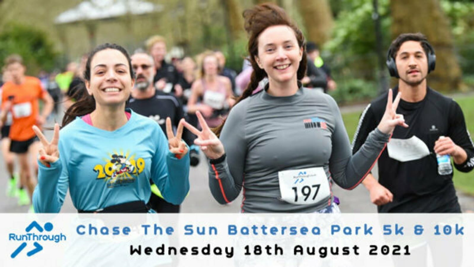 A group of runners participate in the Chase The Sun event at Battersea Park. Two women in the foreground smile and flash peace signs while a man runs closely behind. The event details and date, Wednesday 18th August 2021, are displayed at the bottom.