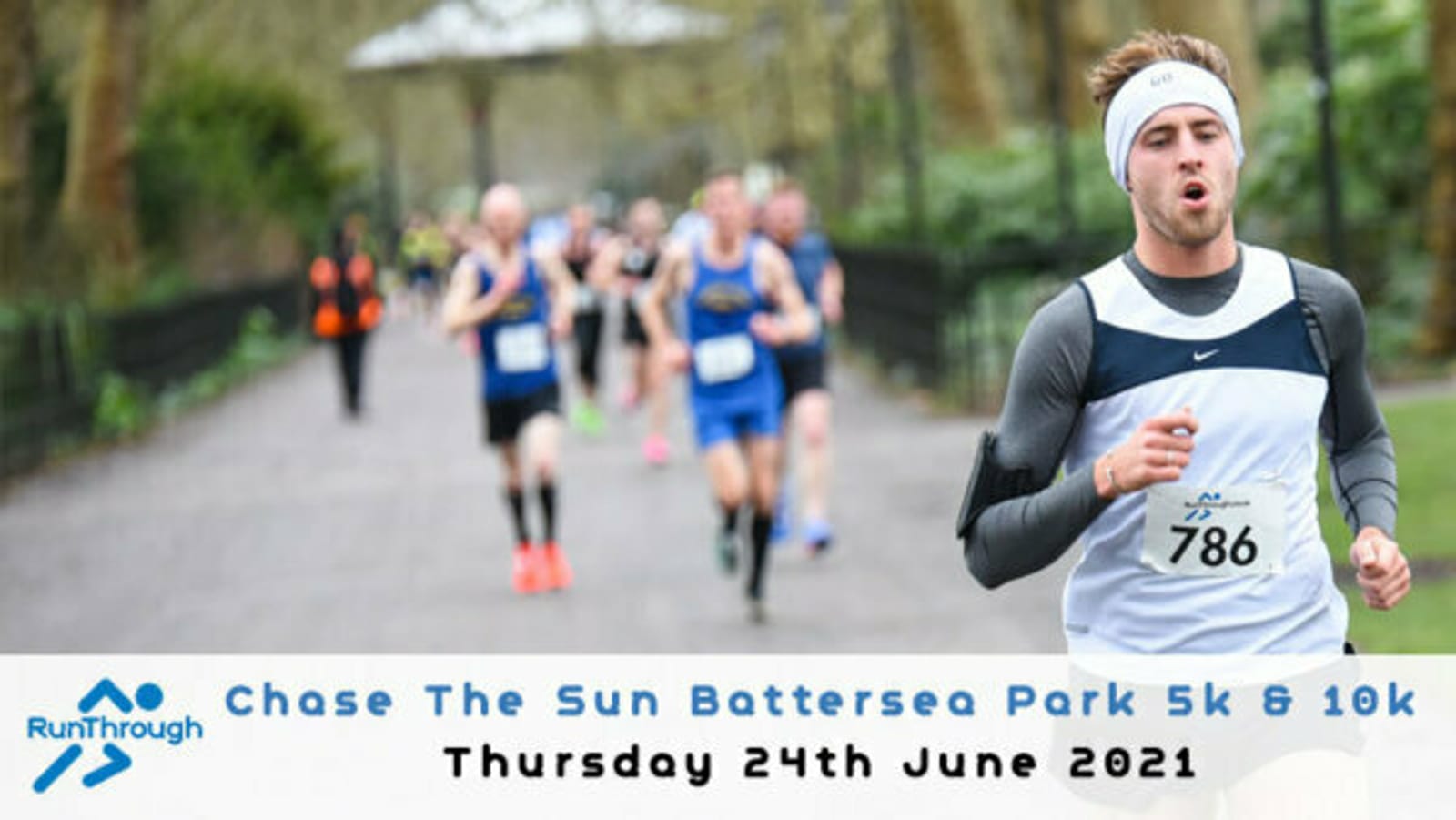 A runner wearing a white headband and gray tank top, tagged with the number 786, competes in the "Chase The Sun Battersea Park 5k & 10k" race on Thursday, 24th June 2021. Several other runners are blurred in the background under a tree-lined path.