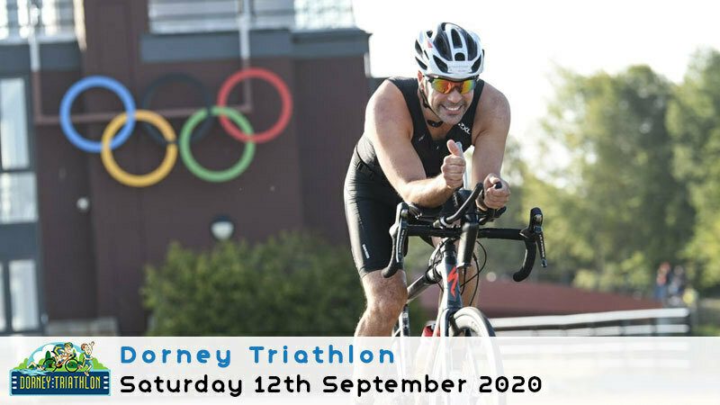 A cyclist rides energetically during the Dorney Triathlon, with the Olympic rings visible in the background. The event details read: "Dorney Triathlon, Saturday 12th September 2020." The triathlon logo is displayed in the bottom left of the image.