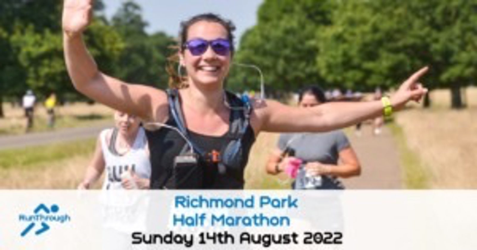 A woman in sunglasses and running gear waves and smiles while participating in the Richmond Park Half Marathon. Other runners are seen in the background on a tree-lined path. Text at the bottom reads "Richmond Park Half Marathon, Sunday 14th August 2022.