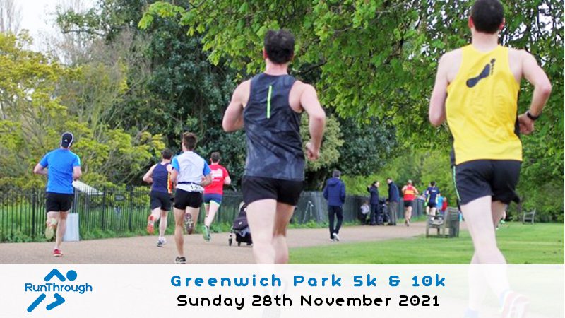 Runners participate in a race along a pathway in a park with trees in the background. Most are wearing athletic gear and bibs. A banner at the bottom reads "Greenwich Park 5k & 10k, Sunday 28th November 2021," with RunThrough's logo on the left.