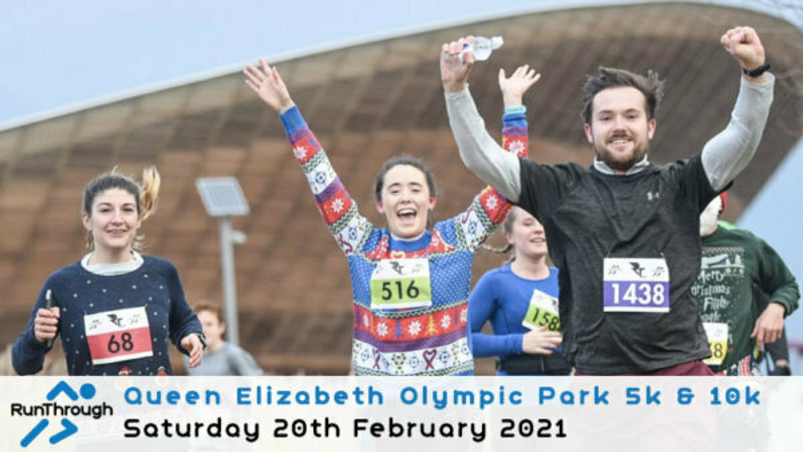 Three people running and smiling during a race at Queen Elizabeth Olympic Park. Two women wearing festive sweaters are visible, with race numbers 516 and 158. A man, wearing a grey sweater and race number 1438, raises his hand in celebration. Text reads "Queen Elizabeth Olympic Park 5k & 10k, Saturday 20th February 2021.