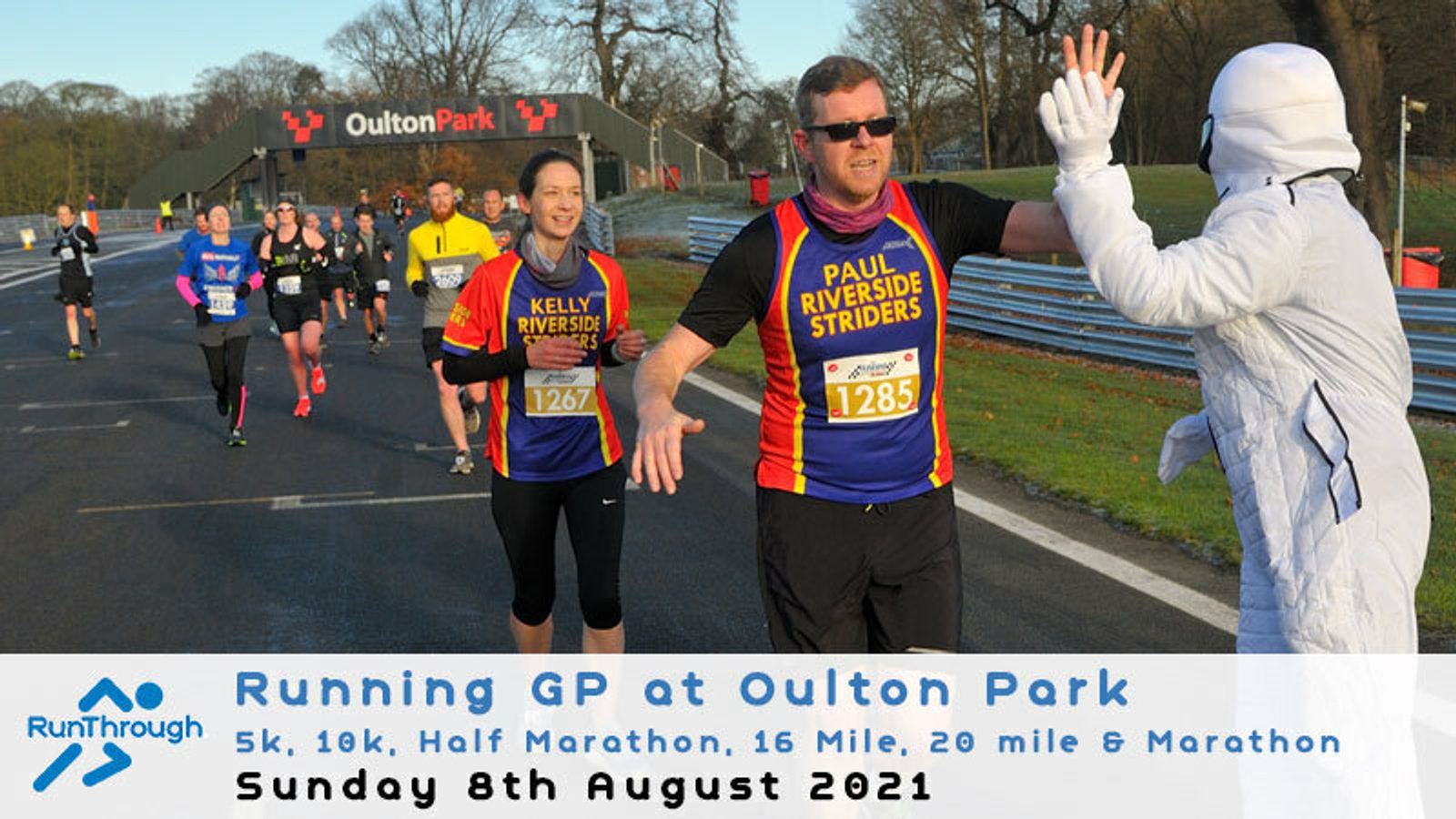 Runners participate in the Running GP at Oulton Park event. Participants in various colorful outfits run on a race track. A person in a white costume high-fives a runner. The event offers multiple race distances as indicated by the text at the bottom.