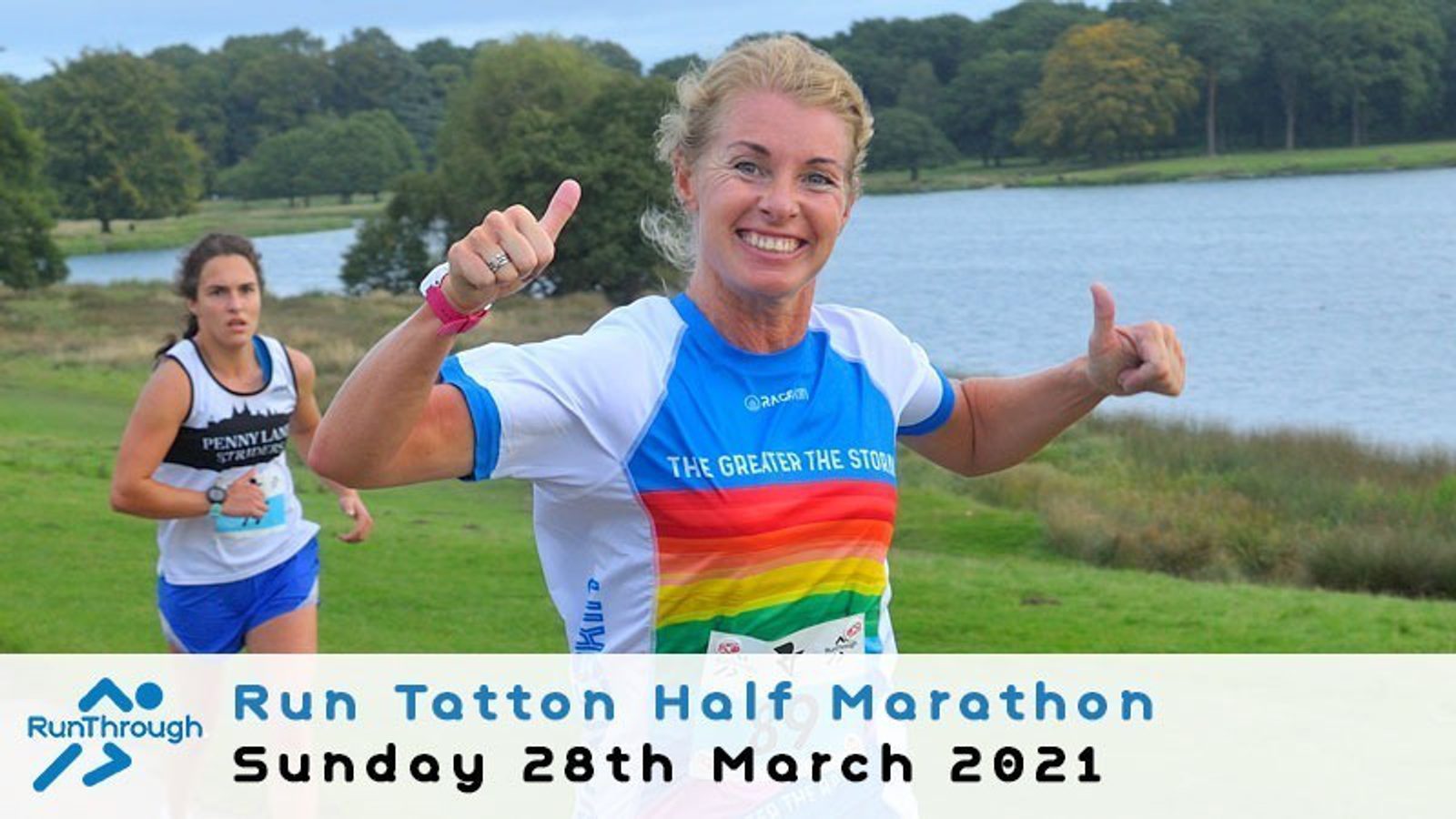 A woman running and smiling with both thumbs up in the "Run Tatton Half Marathon" event. She is wearing a blue and white top with a rainbow design. Another runner is visible in the background. The event date is Sunday, 28th March 2021.