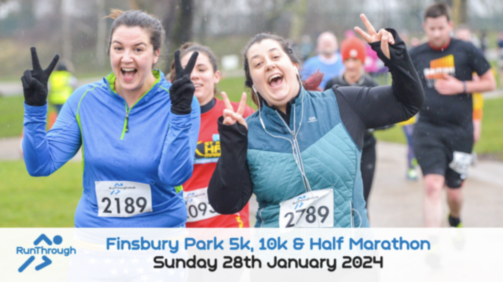 Two excited runners smile and flash peace signs as they participate in a Finsbury Park event. The blurry background shows other runners on the path. Text at the bottom reads: "Finsbury Park 5k, 10k & Half Marathon Sunday 28th January 2024.