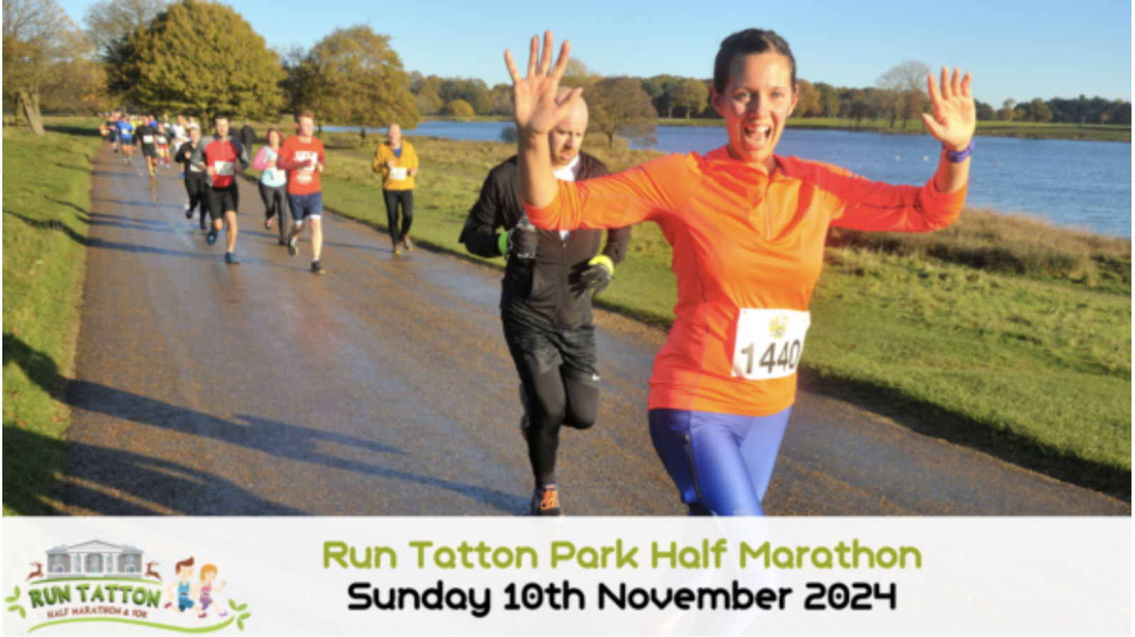 A group of runners participates in the Run Tatton Park Half Marathon. The focus is on a smiling woman in an orange top and blue pants, waving to the camera. The event details are displayed on a banner: Sunday, November 10th, 2024. A scenic park and lake are in the background.