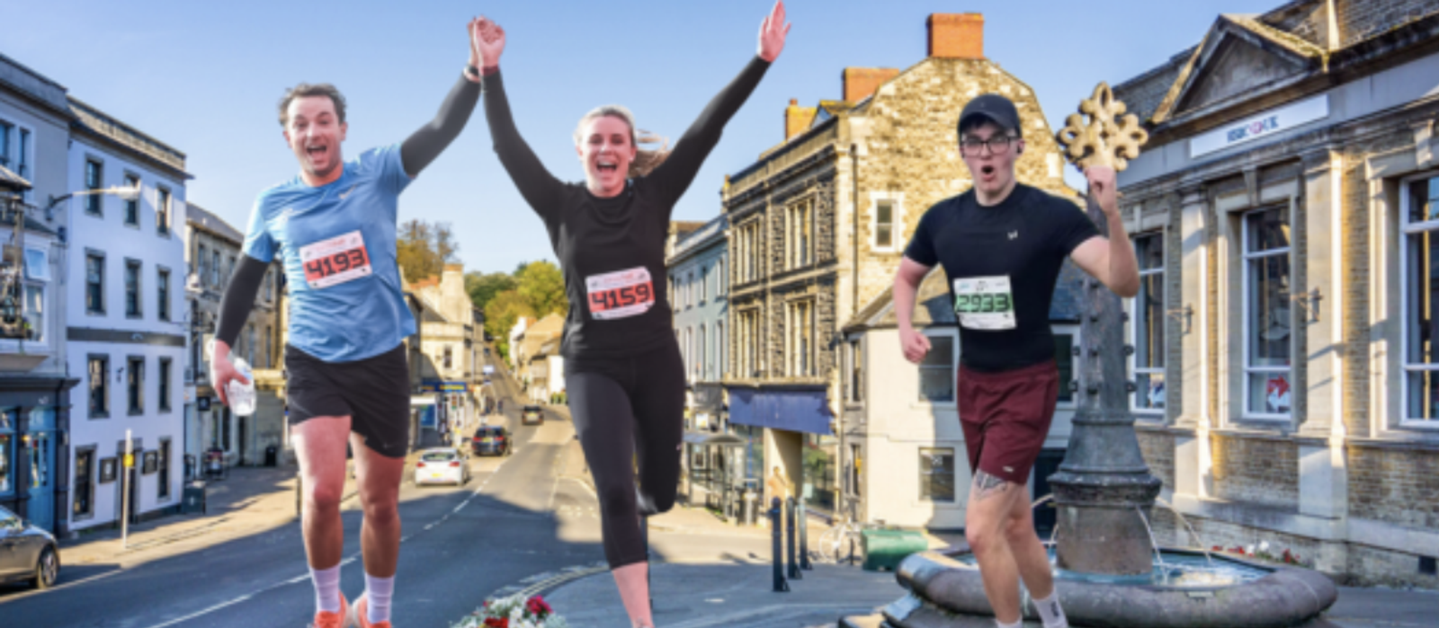 Three runners are in a race on a city street. Two runners, wearing bibs 4593 and 4596, hold hands and smile. The runner on the right, wearing bib 2322 and glasses, holds a golden key. Historic buildings line the street in the background.