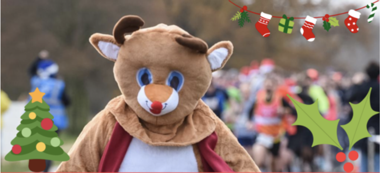 A person in a brown reindeer costume stands in the foreground with a festive Christmas-themed border featuring a tree, stockings, gifts, and holly. Behind them, a group of runners is participating in a race, with trees and a slightly blurred background.