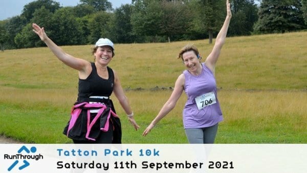 Two smiling women in athletic wear run outdoors on a path, raising their arms in celebration. One has a race bib numbered 706. The background is grassy with trees. Text reads: Tatton Park 10k, Saturday 11th September 2021.