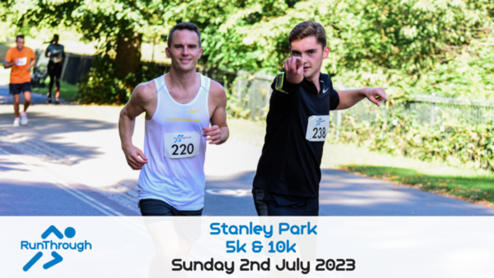 Two runners with bib numbers 220 and 238 participate in a race at Stanley Park on a sunny day. The runner on the right is pointing to the camera. Event details, "RunThrough Stanley Park 5k & 10k, Sunday 2nd July 2023" are displayed below the image.