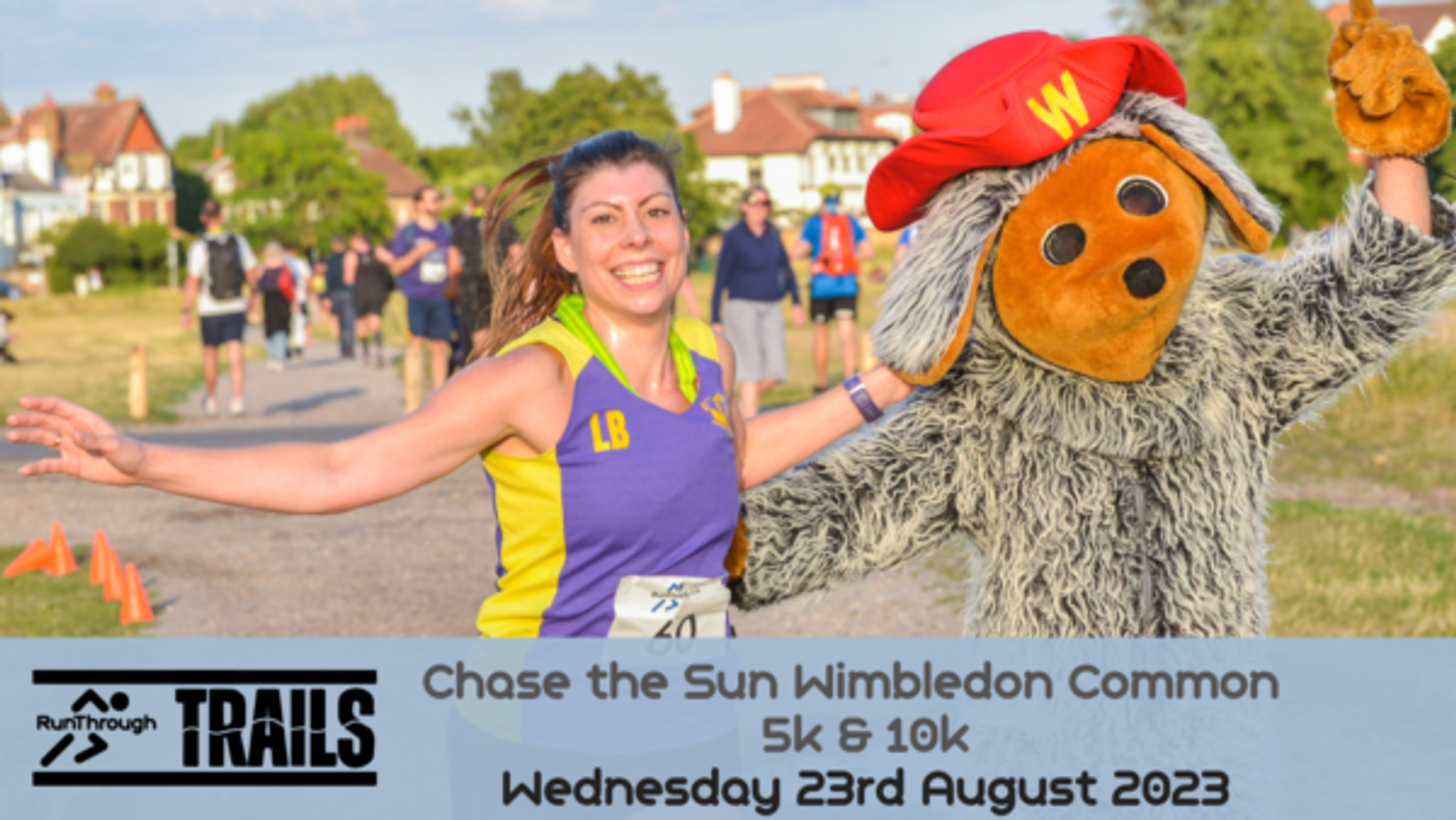 A female runner in a purple and yellow sports outfit and bib number "LW" poses happily next to a person in a large, furry costume. In the background, other participants are visible. The text at the bottom reads: "Chase the Sun Wimbledon Common 5k & 10k, Wednesday 23rd August 2023".