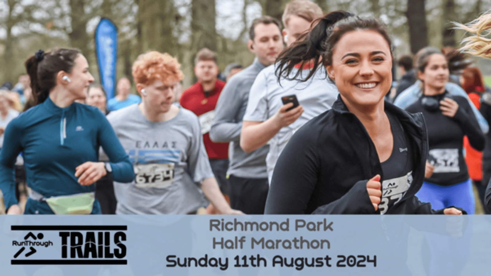 A group of runners are participating in the Richmond Park Half Marathon. A smiling woman in a black jacket is in the foreground. The event details are displayed at the bottom: "Richmond Park Half Marathon, Sunday 11th August 2024." The Run Through Trails logo is on the left.