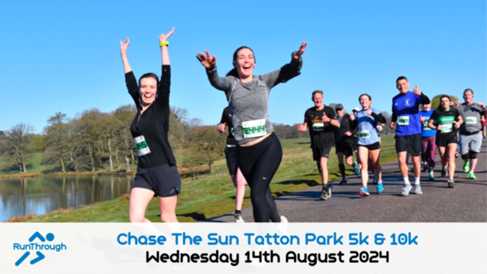A group of people running along a scenic path next to a reflective lake during a race. They are smiling and appear energetic, with some raising their hands in excitement. The event is titled "Chase The Sun Tatton Park 5k & 10k" and is scheduled for Wednesday, 14th August 2024.