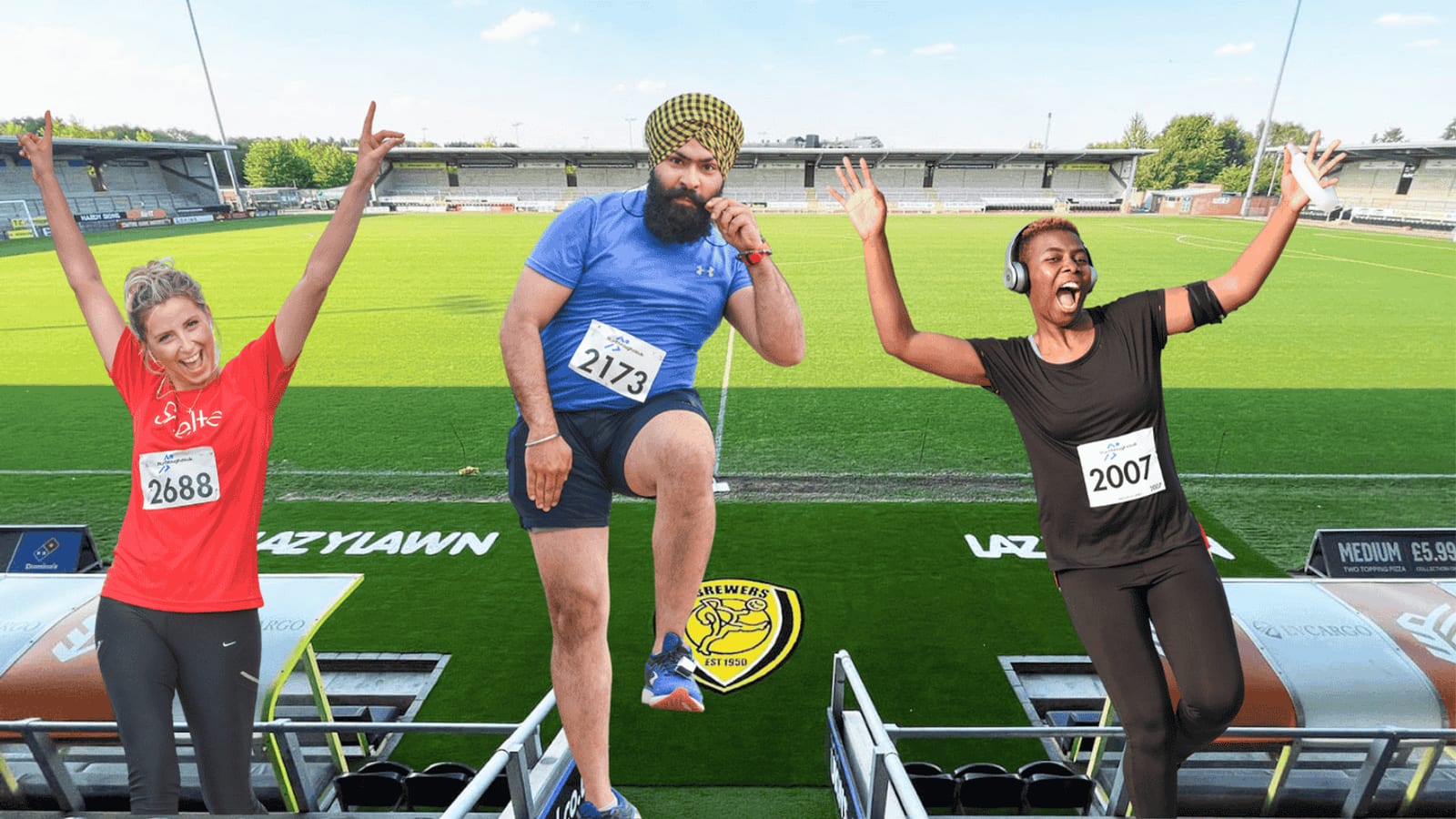 Three marathon runners posing and celebrating on a football field: a smiling woman in a red shirt, a man in a blue shirt and turban raising his knee, and a joyful woman in black wearing headphones. Stadium seats and field in the background.