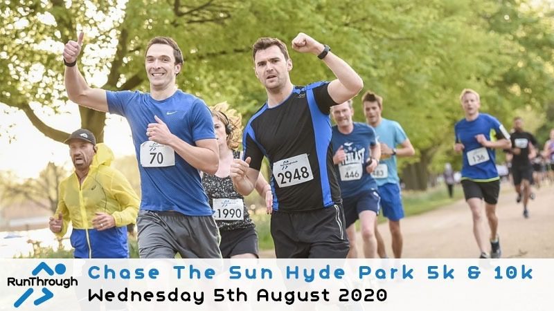 Two runners in a park, one in a blue shirt (bib number 70) and one in a black and blue shirt (bib number 2948), smile and raise their arms in victory. Other runners are visible in the background. Text at the bottom reads "Chase The Sun Hyde Park 5k & 10k, Wednesday 5th August 2020".