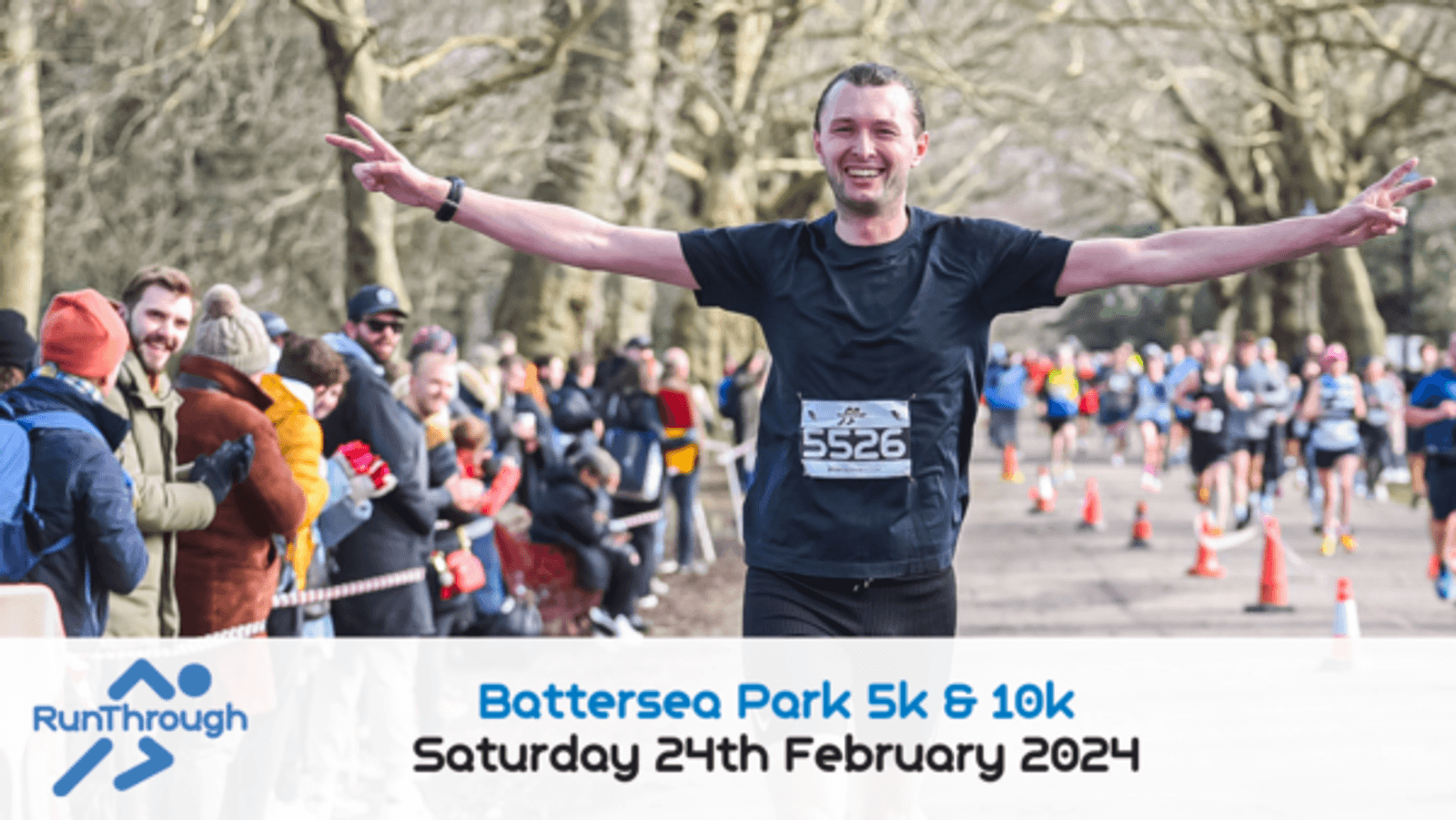 A runner wearing bib number 5526 raises his arms in celebration as he crosses the finish line of a race. Spectators cheer from the sidelines. The text at the bottom reads, "RunThrough Battersea Park 5k & 10k Saturday 24th February 2024.