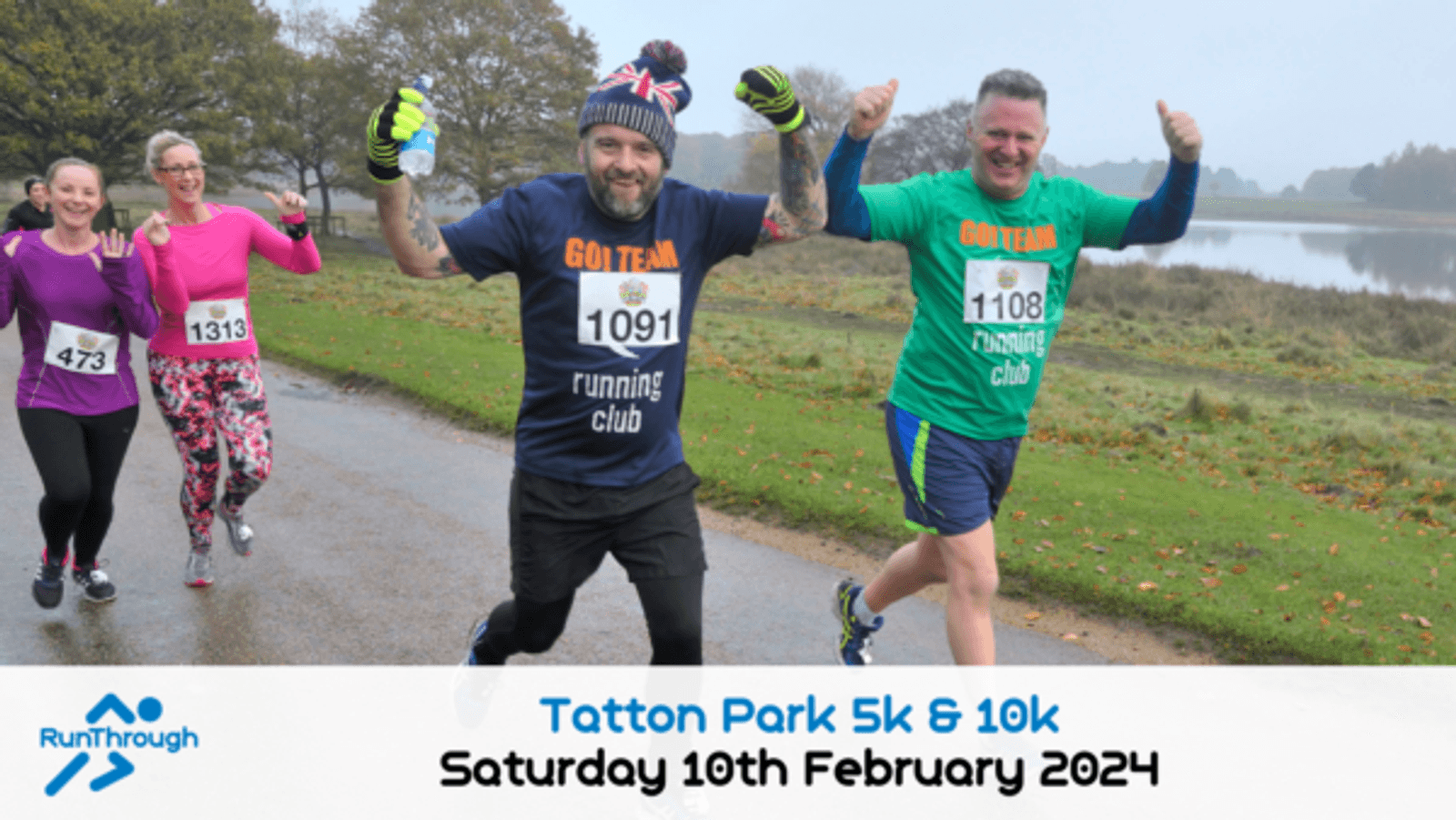 Participants in the Tatton Park 5k & 10k run, including a man in a "Go Team" running club shirt, cheer and smile as they run beside a lake on a cloudy day. Two women and another man are running behind them. The event date is Saturday, 10th February 2024.
