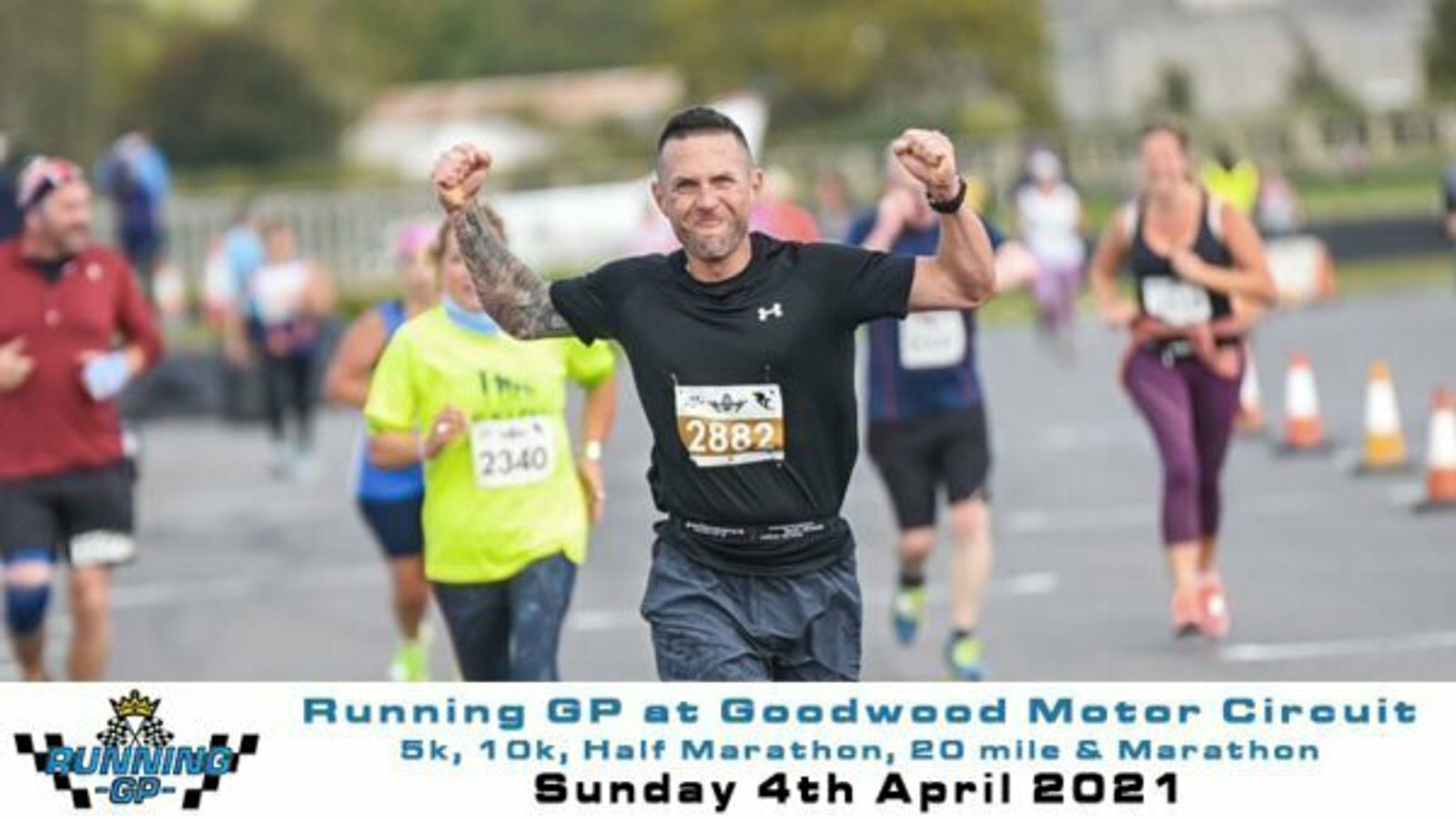 A man with a race bib number 2882 is running in an event at Goodwood Motor Circuit. He is wearing a black running outfit and has a tattoo on his left arm. Other runners are seen in the background. The text on the image mentions different race categories and the date, April 4, 2021.