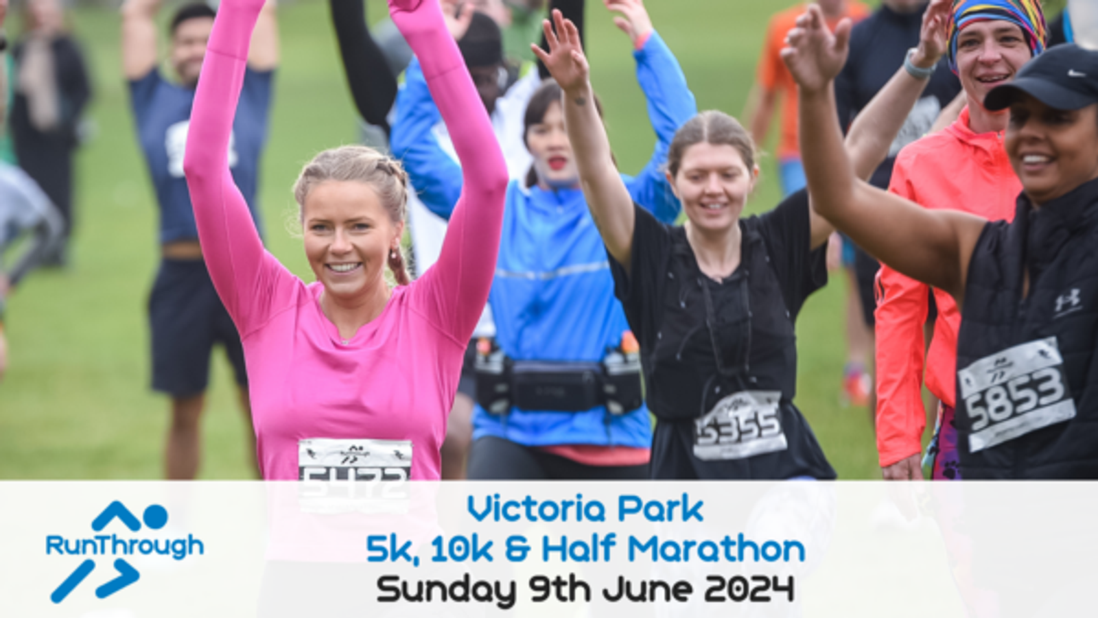 A group of runners raise their arms and smile as they participate in a race at Victoria Park. The event includes a 5k, 10k, and half marathon, taking place on Sunday, June 9, 2024. Participants wear race numbers and athletic gear.